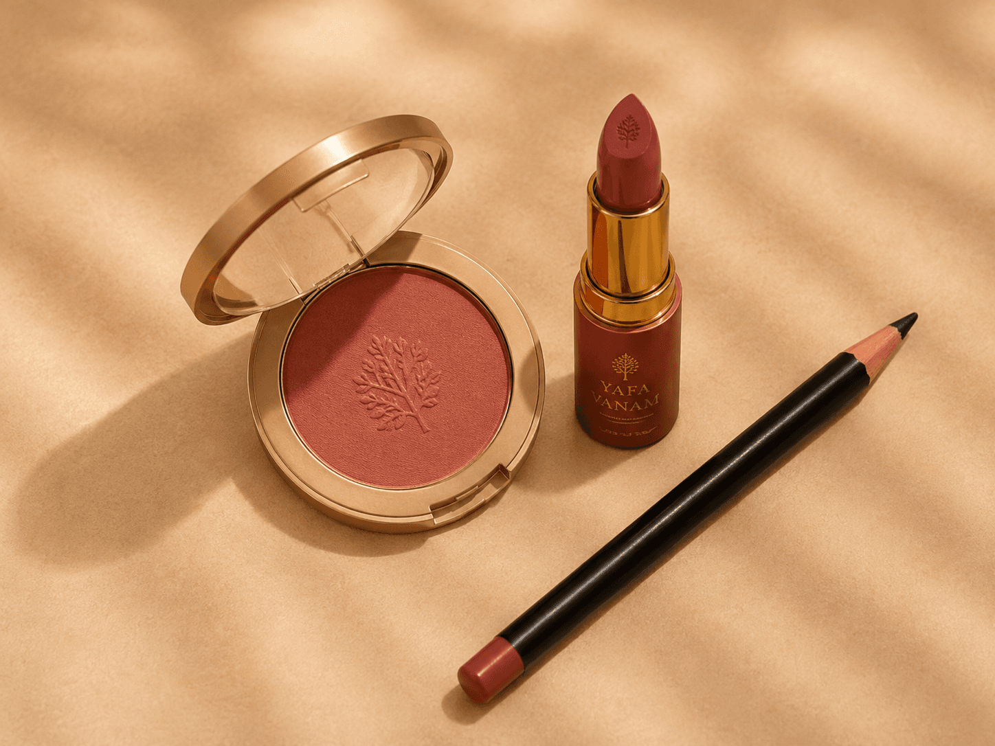 YAFA VANAM blush, lipstick and pencil arranged as a makeup editorial